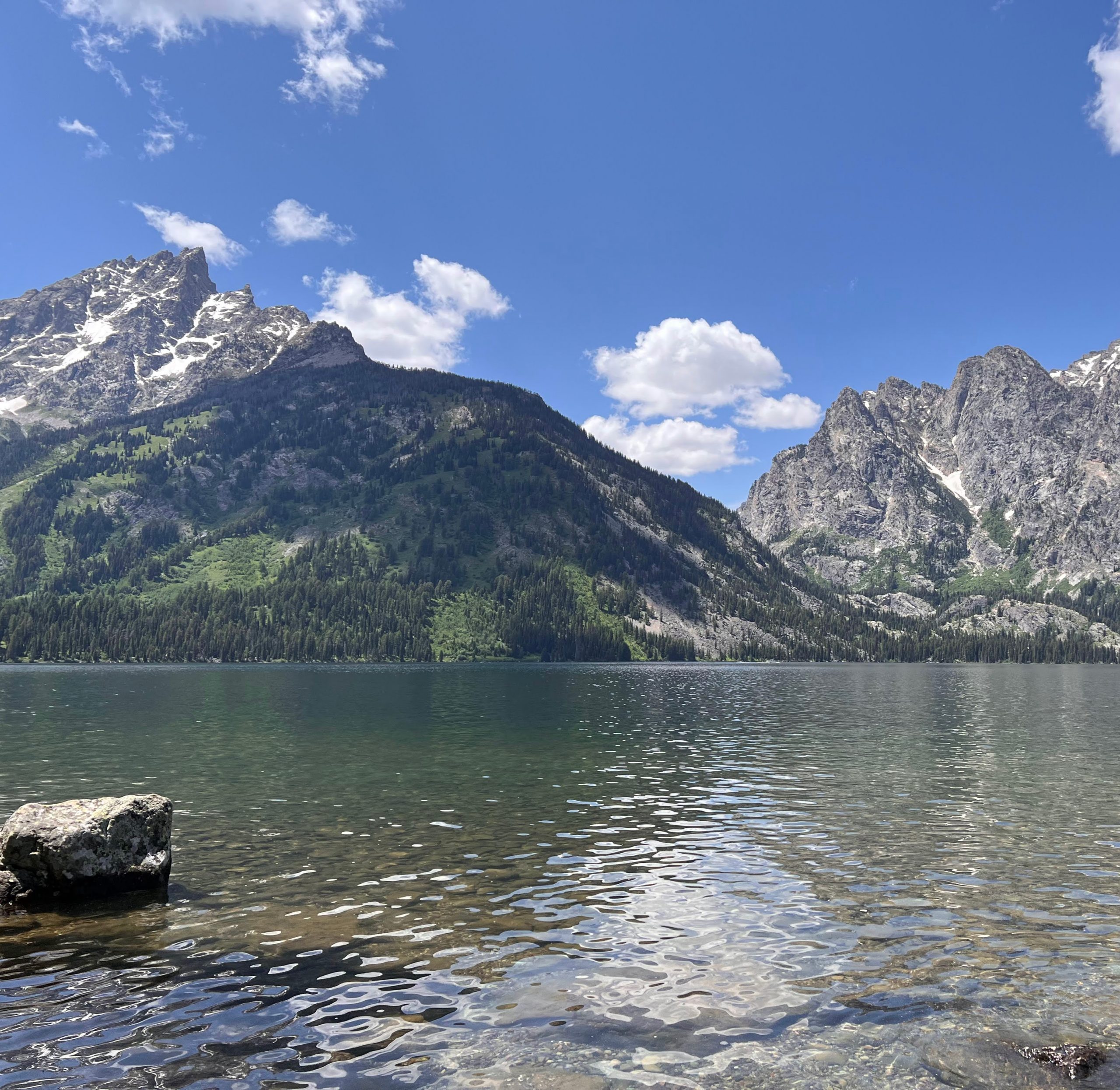 Lakeside view of Jenny Lake in the Grand Tetons, with teton mountains in the background.