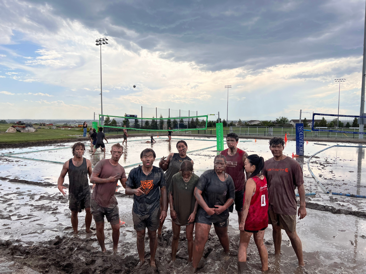 Group of people playing mud volleyball in rexburg.