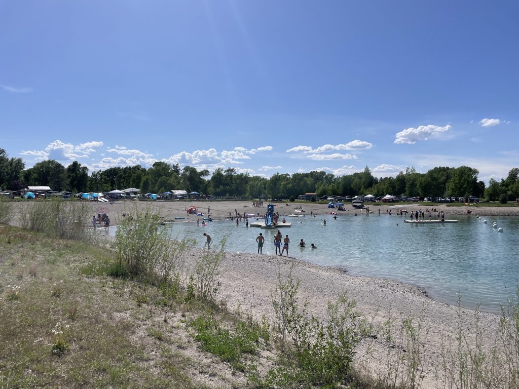 People swimming and playing at Jefferson County Lake left half or it's also called Rigby Lake by the locals.