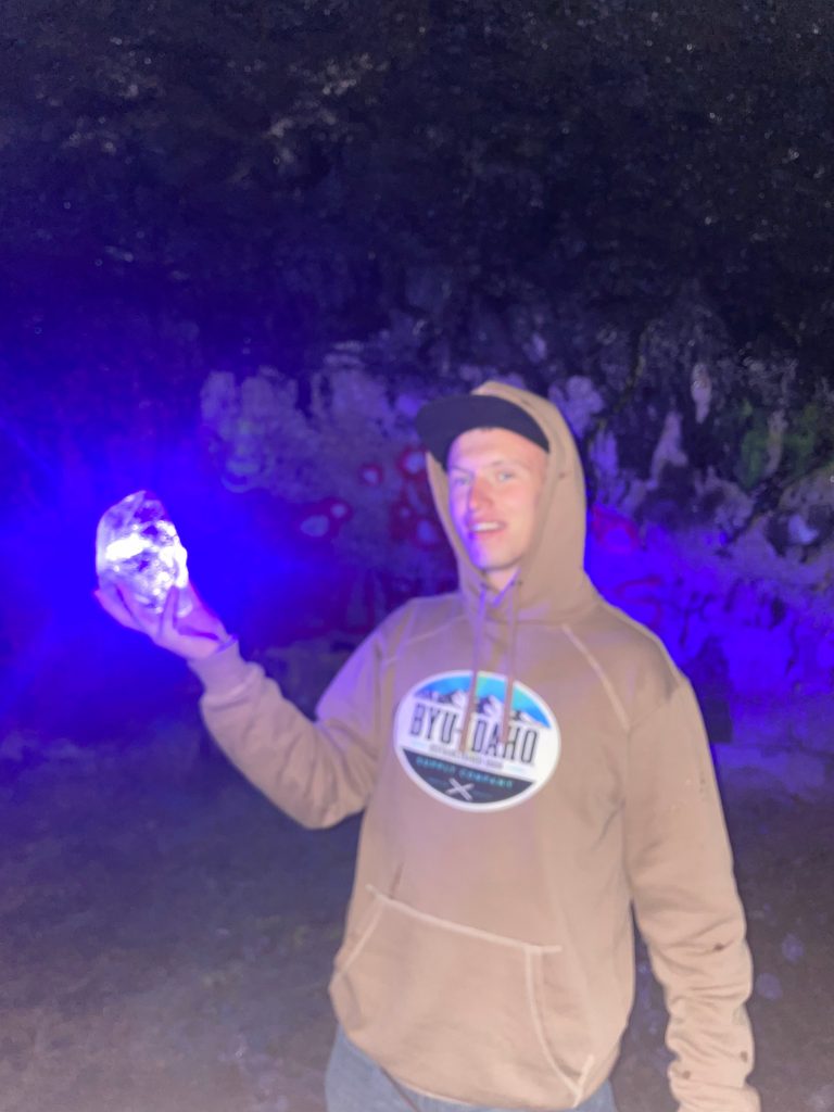 Me holding a iceblock with a laser pointed at it to make it glow in the Civil Defense Caves.