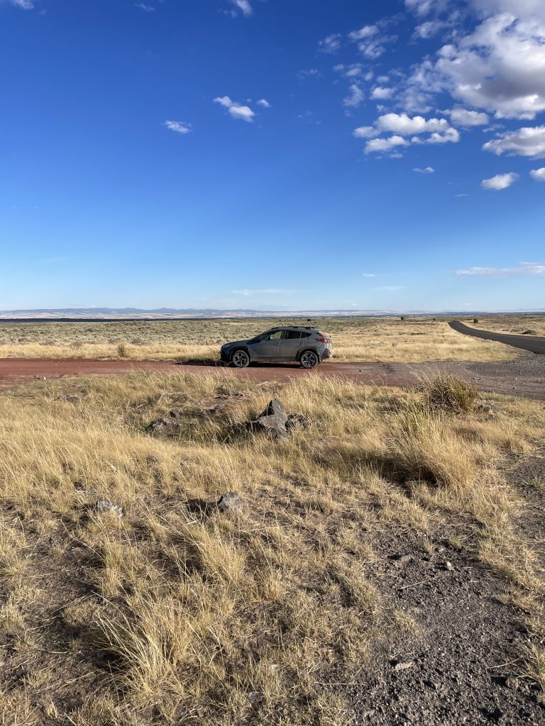 Our Subaru Crosstrek on the red dirt trail that turns of from the road toward the Civil Defense Caves.