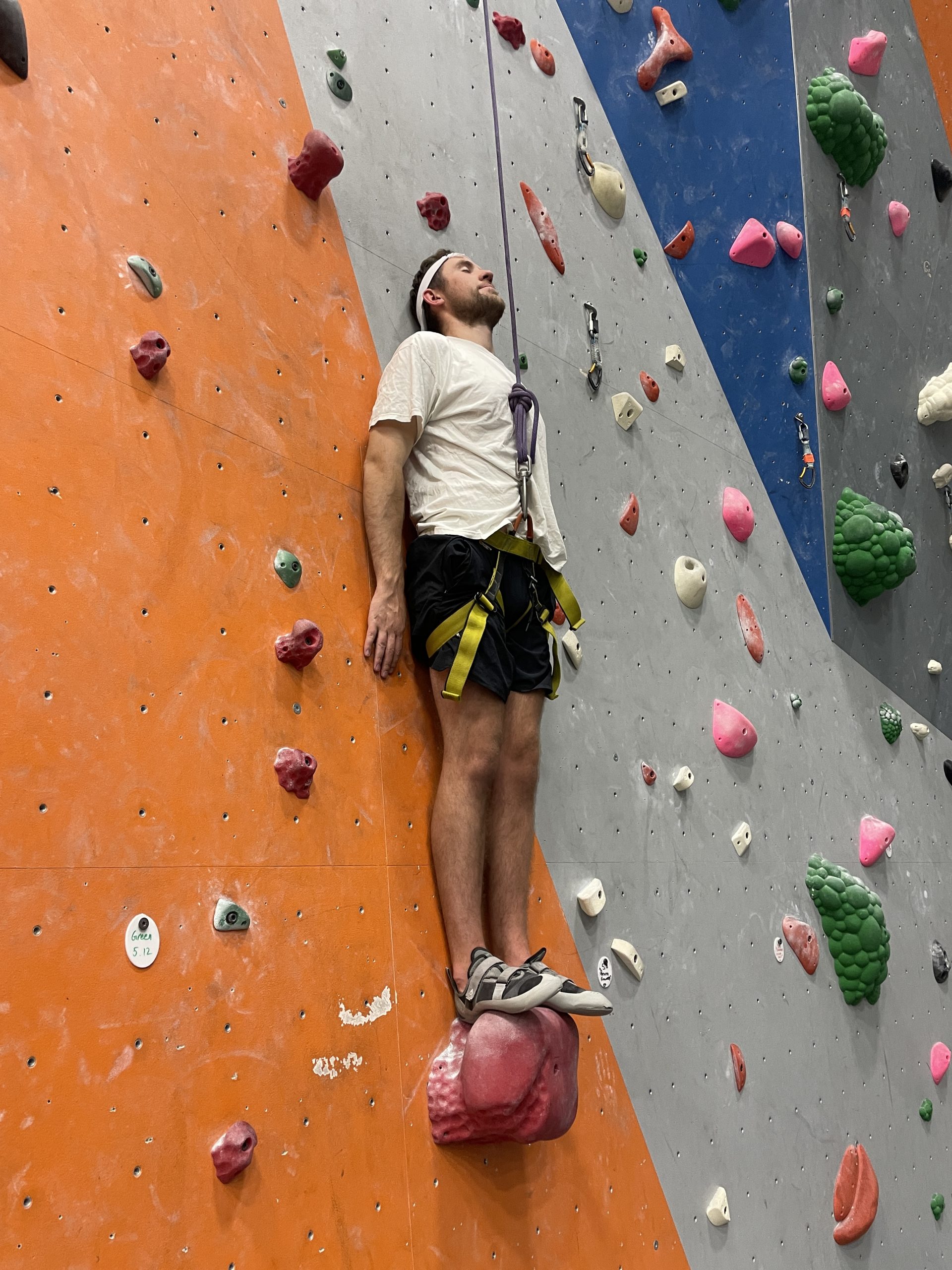 My friend posing on the rock wall to look like free solo at the Rock Gym in Rexburg Idaho.