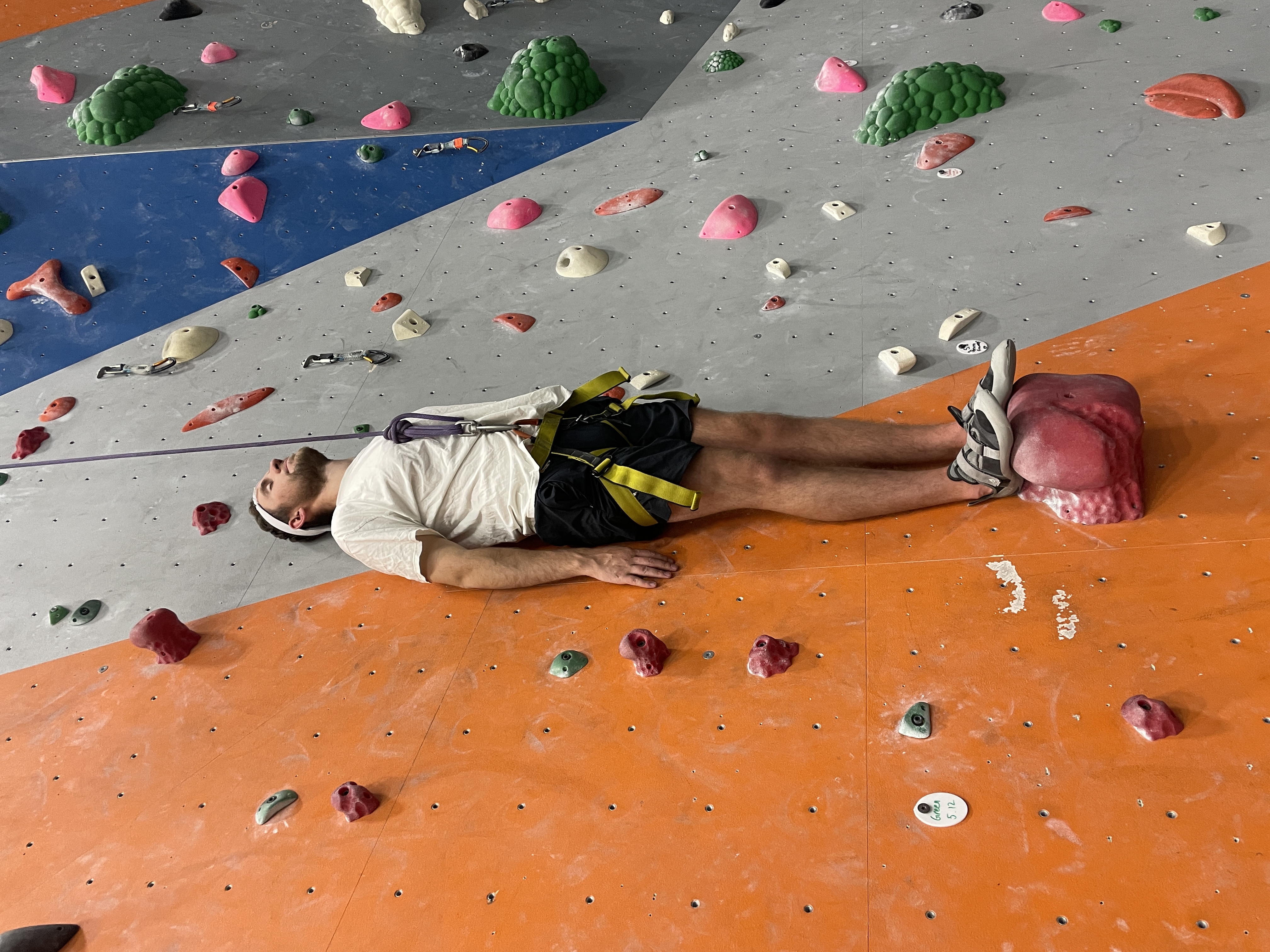 My friend posing on the rock wall to look like free solo at the Rock Gym in Rexburg Idaho.