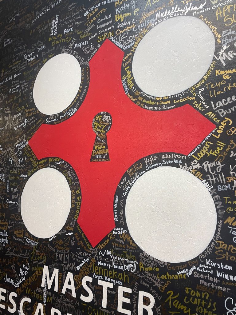 Lobby hallway at Rexburg Re-Escape featuring signed wall of past players