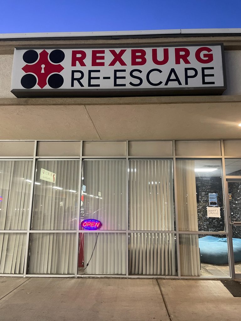 Rexburg Re-Escape storefront sign on Main Street in Rexburg Idaho at night