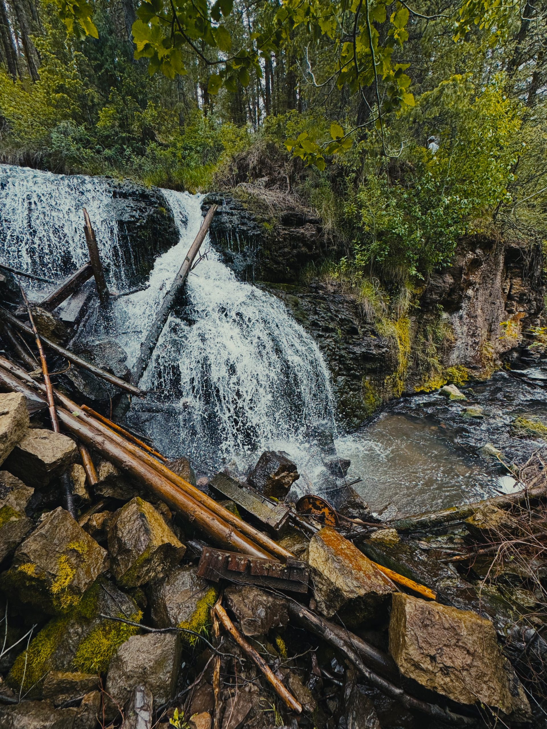 Close-up of the Webster Dam waterfall pouring over old timbers and rocks
