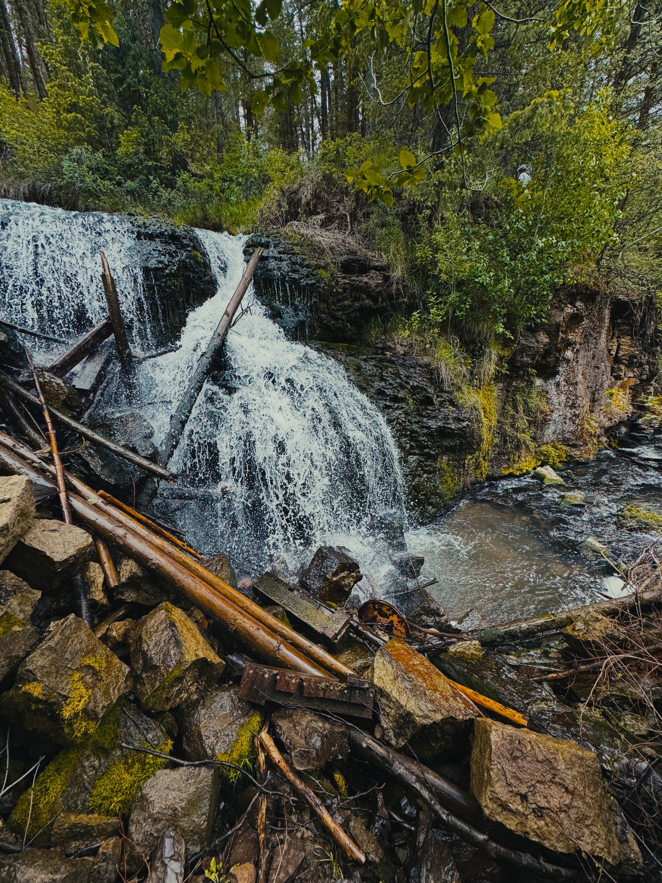Close-up of the Webster Dam waterfall pouring over old timbers and rocks