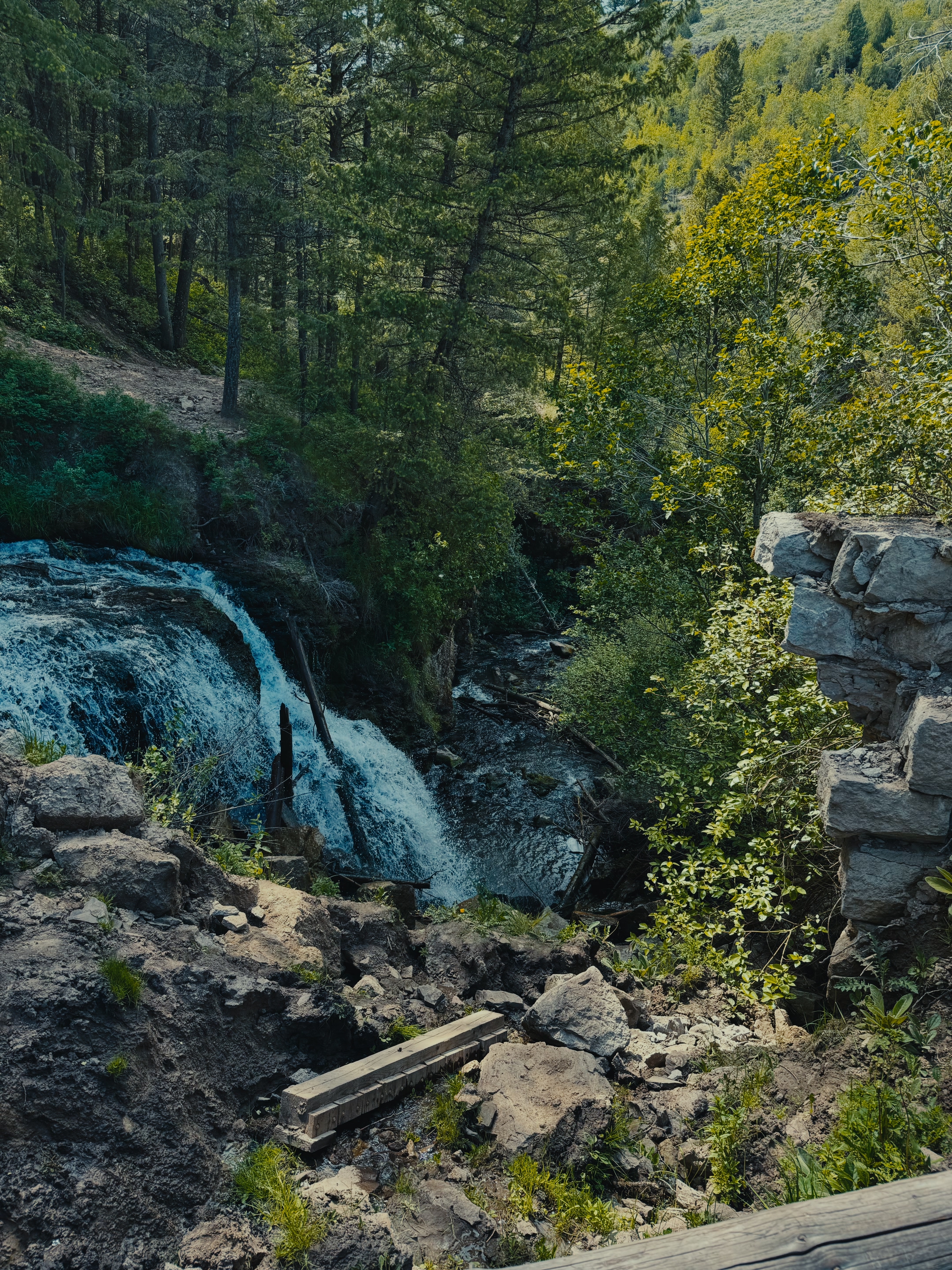 A view of the Webster Dam waterfall cascading over rocks from a nearby overlook