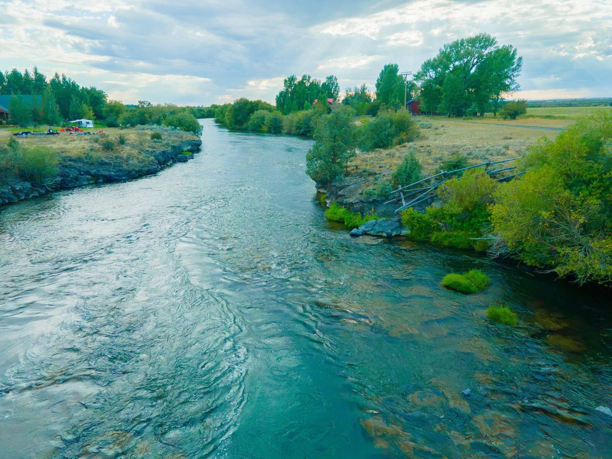 The river near Twin Bridges with a riverside camping area in Rexburg, Idaho